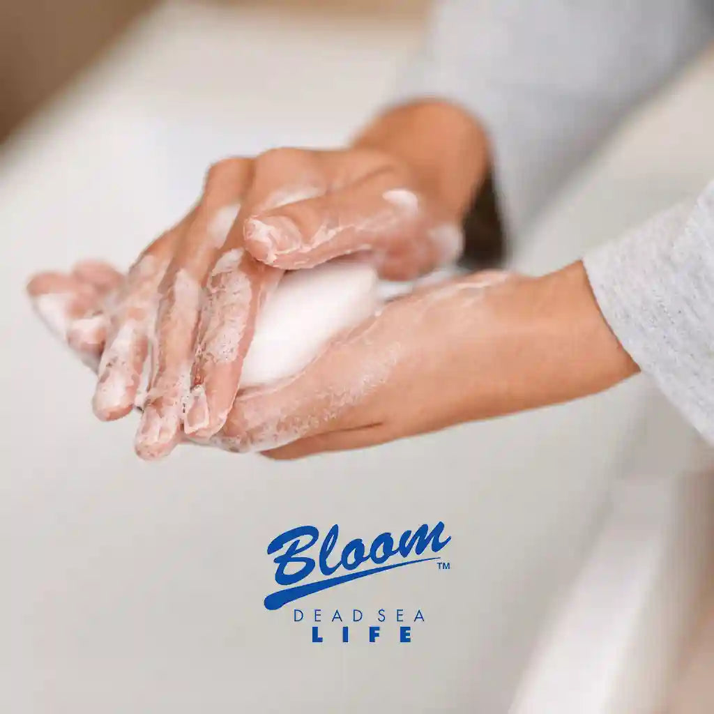 Person washing hands with Bloom Dead Sea Salt Soap, lathering and cleansing with natural ingredients