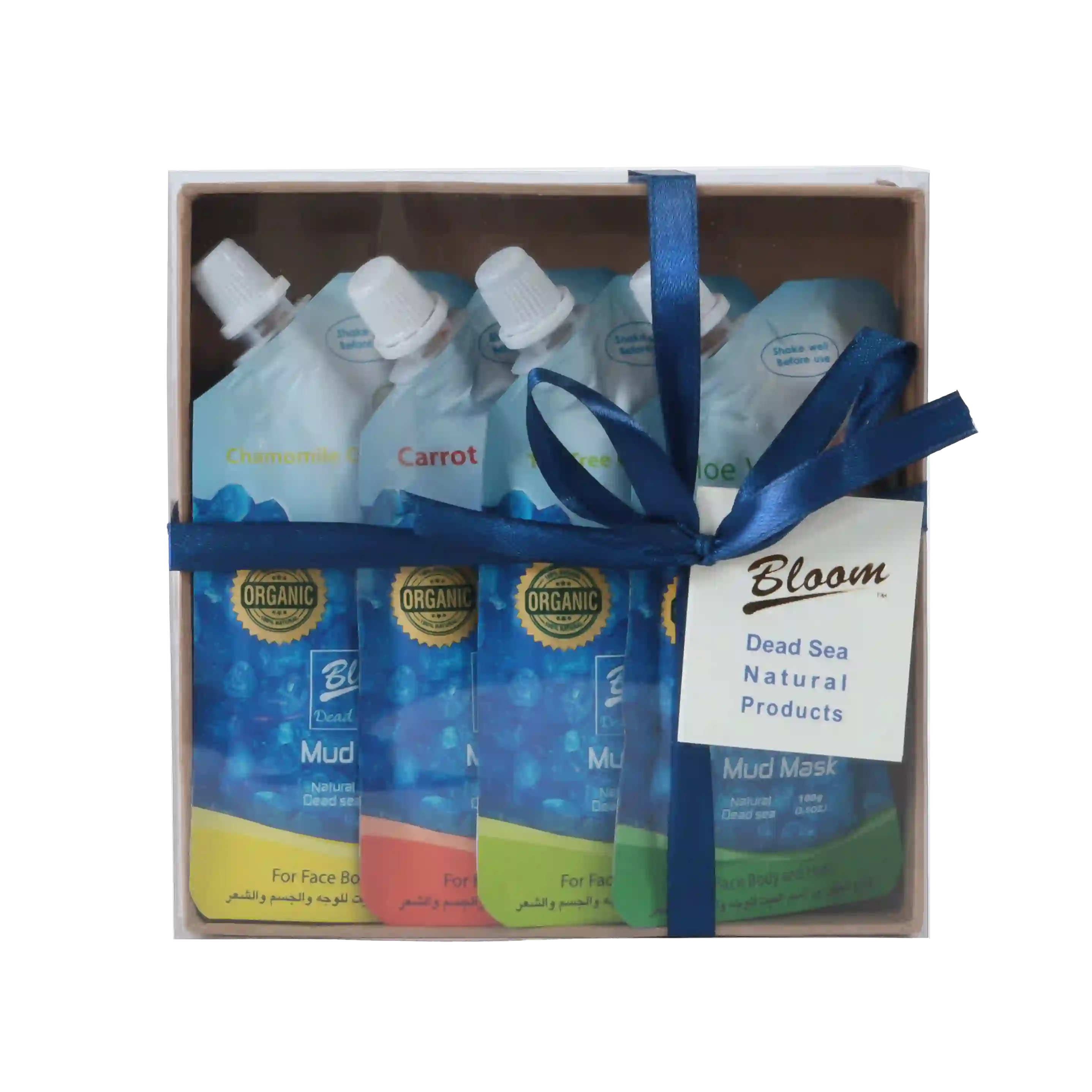 Four jars of Organic Dead Sea Mud Masks with natural ingredients like aloe vera, carrot, chamomile, and tea tree, arranged with spa essentials and Dead Sea salt on a clean, serene background.