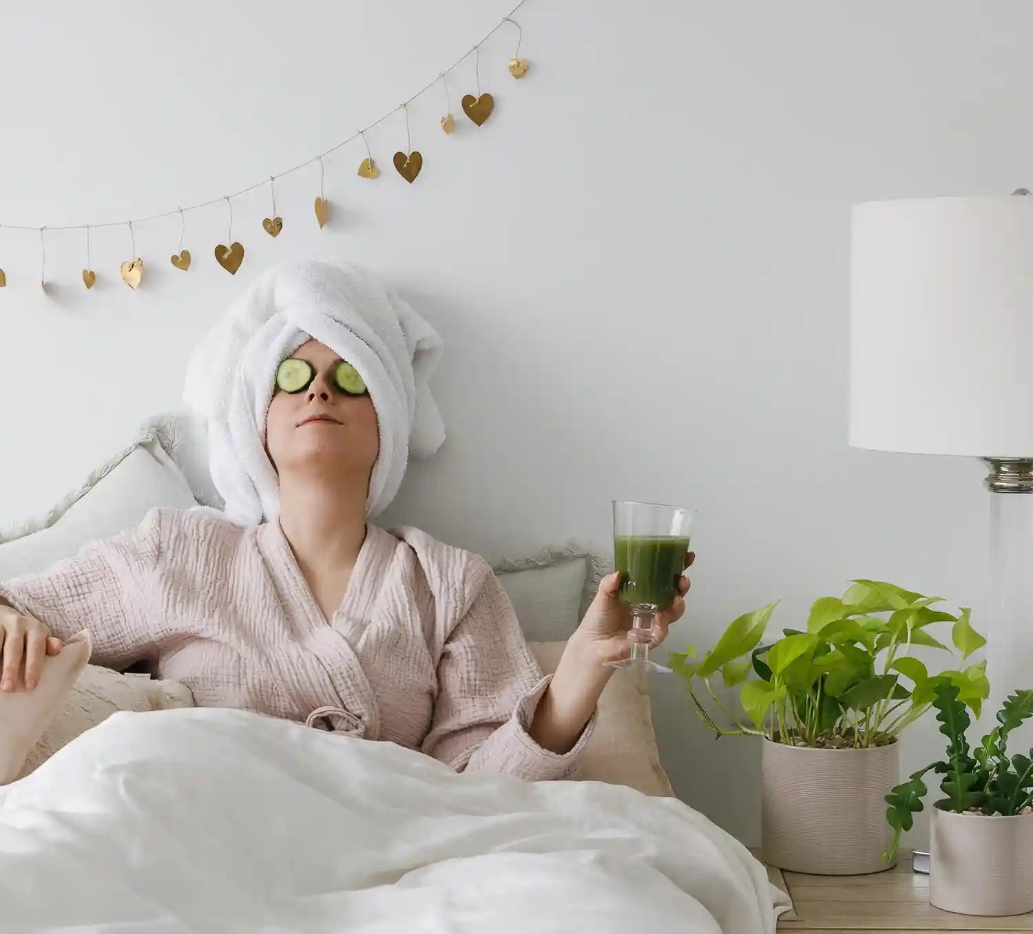 Bloom Dead Sea skincare products arranged for a relaxing spa day at home with candles and towels